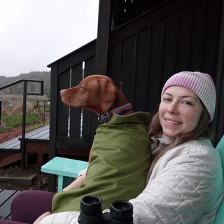Woman and Dog Relaxing on Coastal Deck