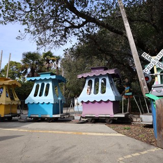 Colorful Miniature Train Stations at Railroad Crossing