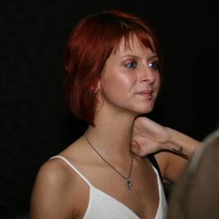 Red-haired woman wearing a necklace