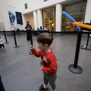 Child Playing with Foam Sword at Asian Art Museum