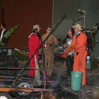 Factory Workers Gather Around Fire