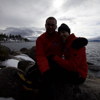Couple Embracing by Snowy Lake Tahoe Shore