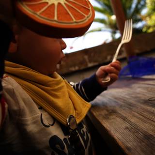 A Zesty Bite: Young Boy with Orange Slice