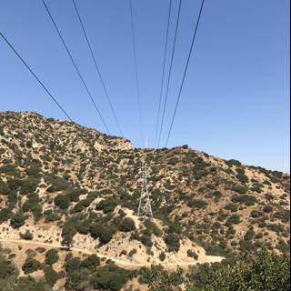 Power lines cutting through the majestic mountains