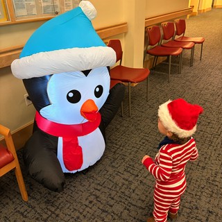Toddler Meeting Inflatable Snowman at Holiday Event