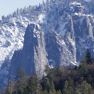 Winter's Majesty: Snow-Covered Granite Cliffs in Yosemite