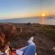 Sunset Overlooking the Ocean with Furry Companion