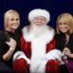 Festive photo with Santa Claus and two women