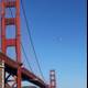 Helicopter hovering over Golden Gate Bridge