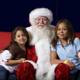 Santa Claus and Two Girls Sitting on a Couch