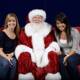 Santa joins the ladies on a red couch