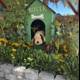 Garden Hideout: A Furry Companion in Bloom