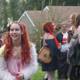 Redhead in Costume with Purse and Luggage Outdoors