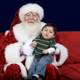 Santa Claus and Child on Festive Red Couch