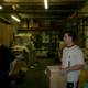 Two Men in a Warehouse Surrounded by Cardboard Boxes