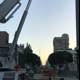 Construction Crane Lifting Equipment onto Busy Los Angeles Street