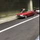 Red Sports Car Cruising Through the Tunnel