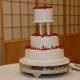 Three Tiered Wedding Cake with Vibrant Red Flowers