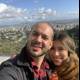 Happy couple captures city skyline in selfie
