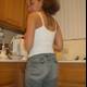 Woman in Jeans Poses in Kitchen