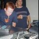 Mastering the Music: Two Men at the DJ Mixer