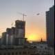 Crane Takes Flight in the Sunset Skyline